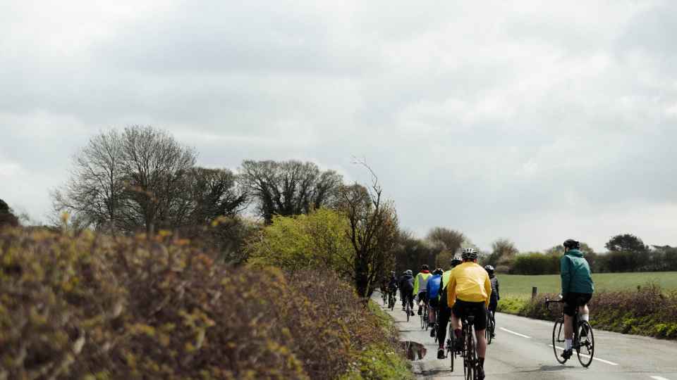 cyclists cycling down country road
