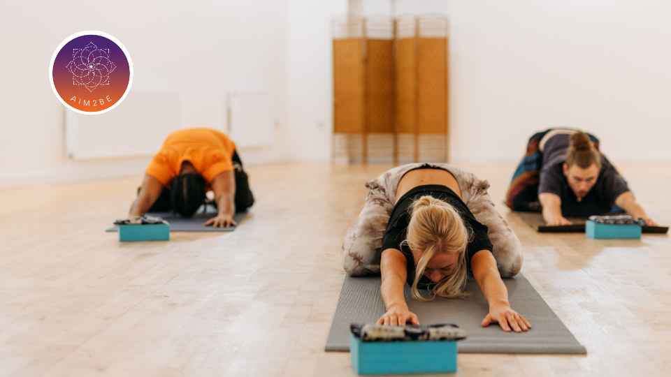 A group of people doing yoga.