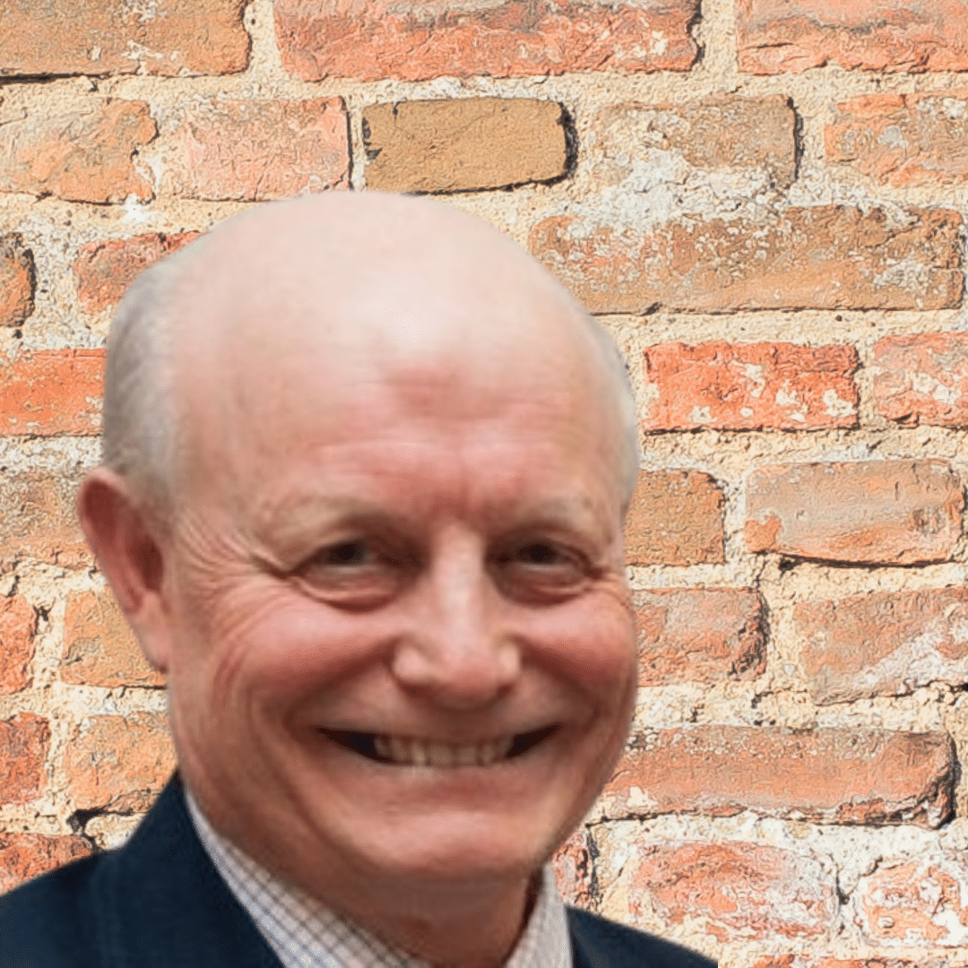 headshot of Tim with a brick background
