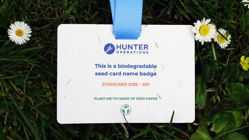 A name badge lanyard on grass.